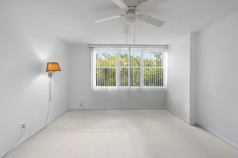 a view of an empty room with a cabinet and a flat screen tv