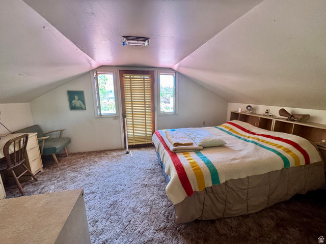 178 Walnut Lane Moab, UT 84532 - Photo 18 of 25 Attic room featuring sloped ceilings, light-colored wall surfaces, and a built-in headboard with integrated shelving