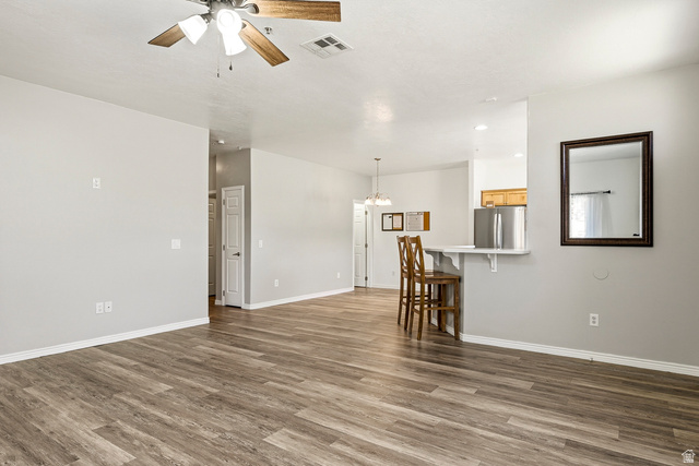 1177 Northfield Road, Unit 26 Cedar City, UT 84721 - Photo 5 of 45 Open-concept living area featuring wood-finish flooring, a ceiling fan with light fixture, and neutral wall tones