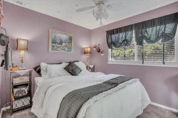 a bedroom with a large bed and a window