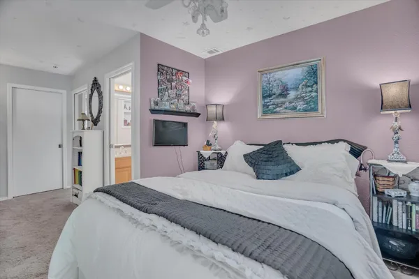 a bedroom with a bed and a chandelier