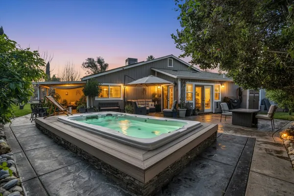 a backyard of a house with yard barbeque oven and outdoor seating