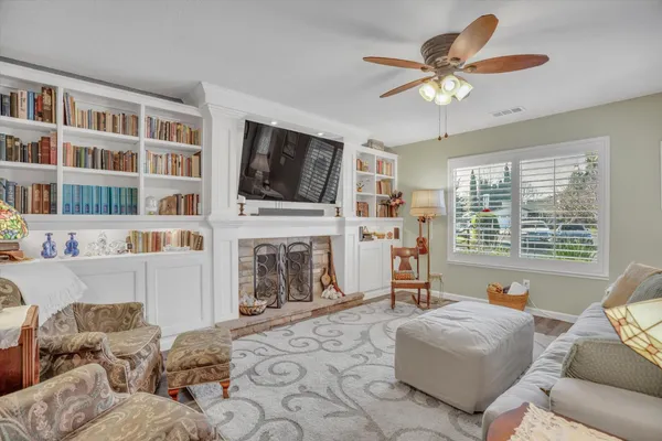 a living room with furniture a fireplace and a flat screen tv