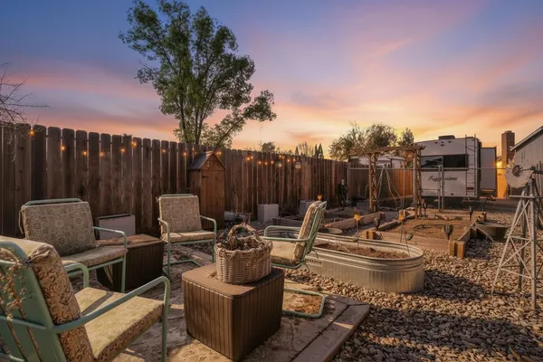 a patio with patio a table and chairs under an umbrella