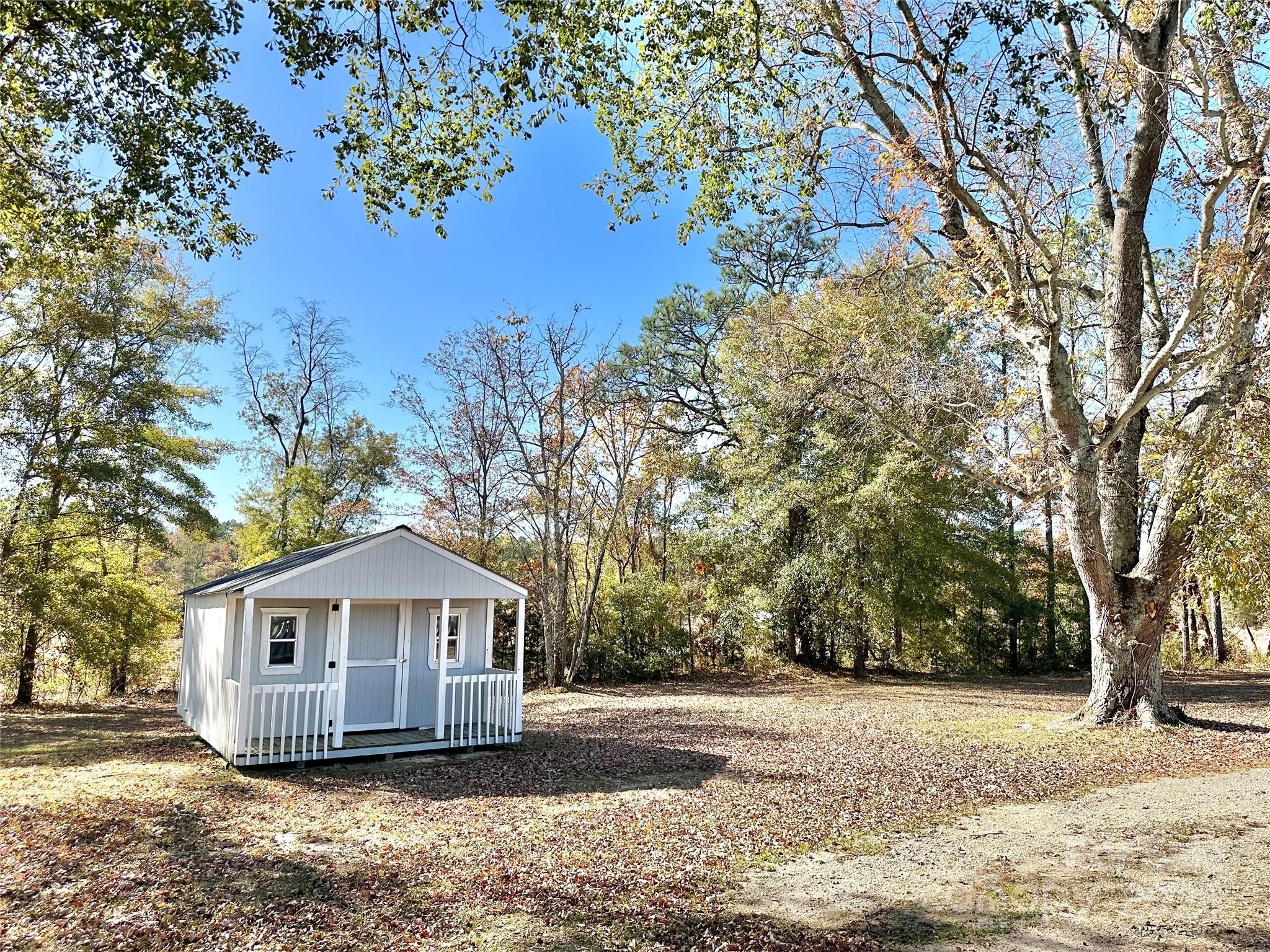 1073 Jones Road Kershaw, SC 29067 - Photo 4 of 18 a front view of a house with a yard and large trees