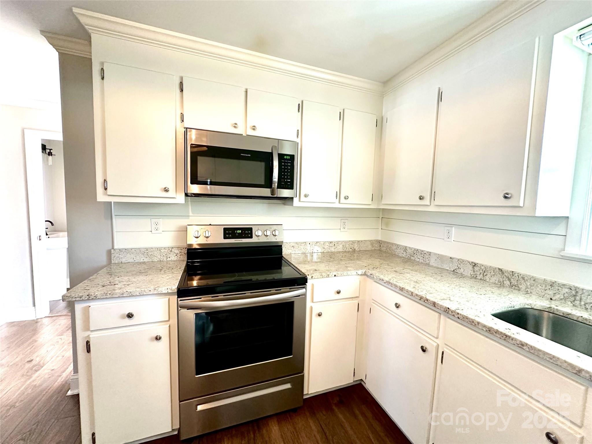 1073 Jones Road Kershaw, SC 29067 - Photo 9 of 18 a kitchen with granite countertop white cabinets white stainless steel appliances and a sink