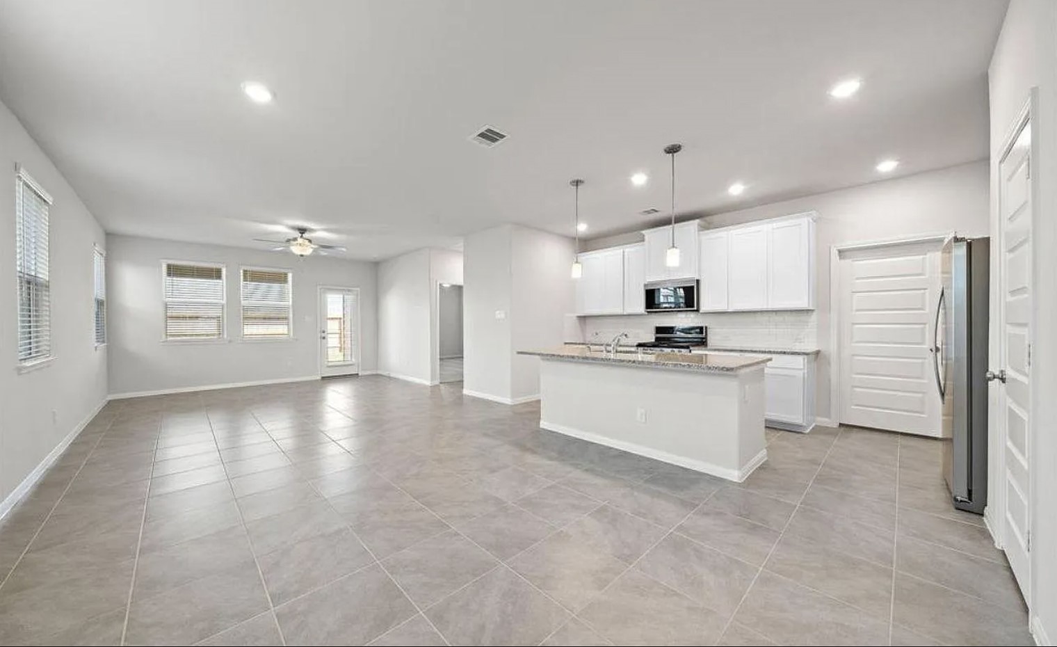 5631 Giving Grace Way Houston, TX 77048 - Photo 2 of 10 a view of a kitchen with refrigerator and white cabinets