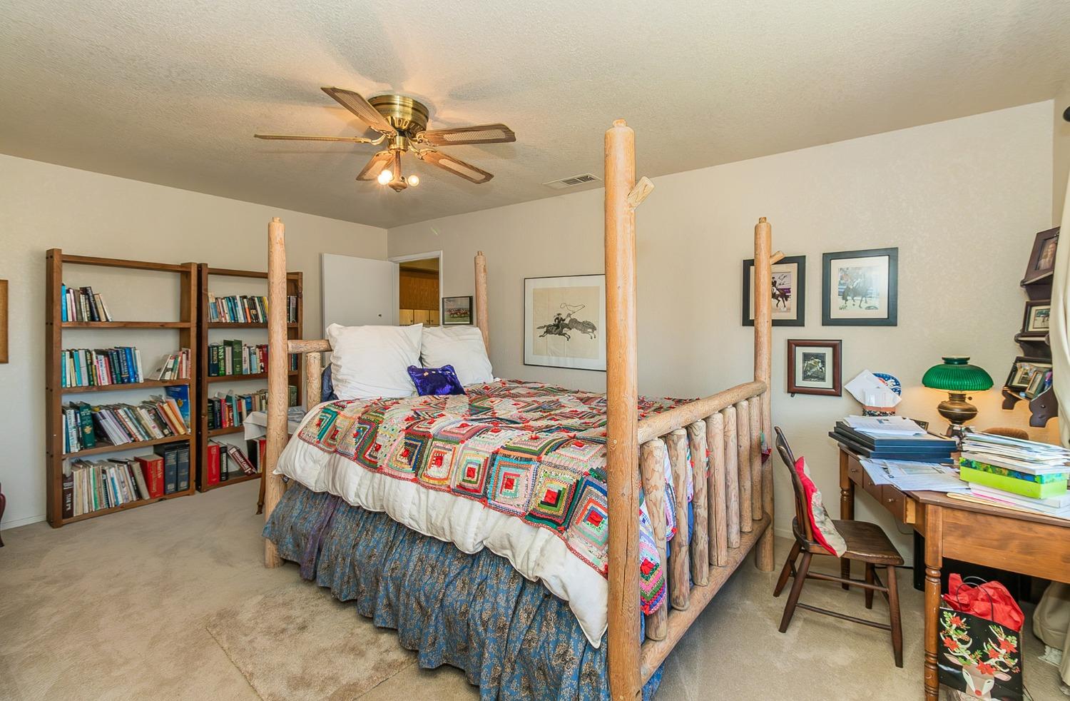 13016 Violet Lane Clovis, CA 93619 - Photo 15 of 41 a bedroom with bed and a chandelier