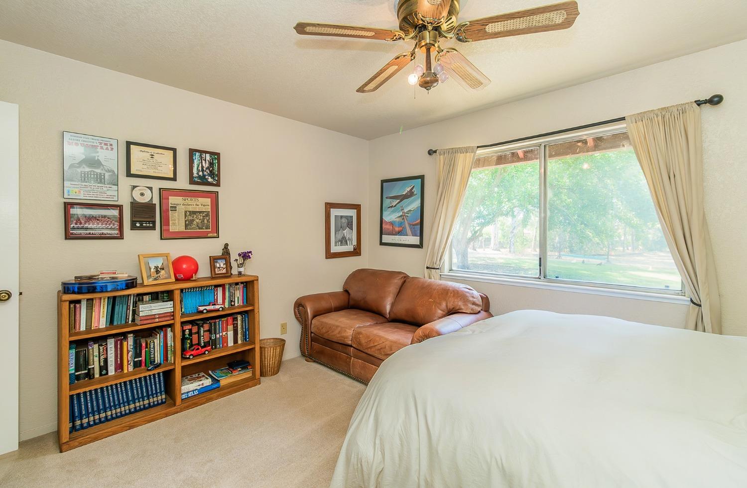 13016 Violet Lane Clovis, CA 93619 - Photo 21 of 41 a bedroom with a bed and a large window
