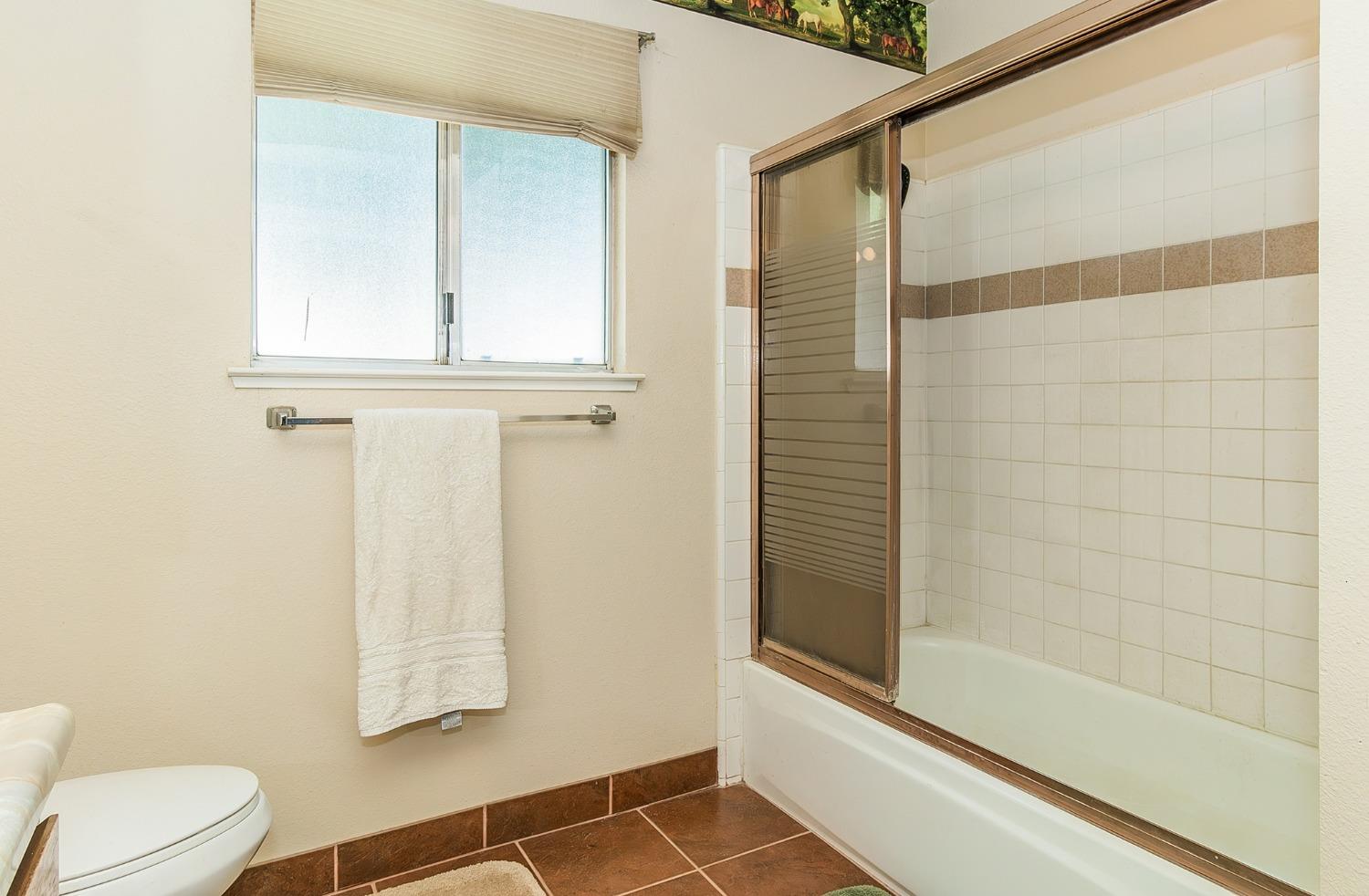 13016 Violet Lane Clovis, CA 93619 - Photo 23 of 41 a bathroom with a window and a shower