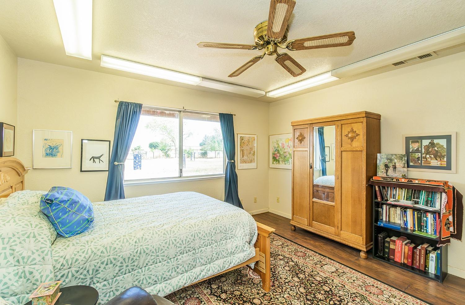 13016 Violet Lane Clovis, CA 93619 - Photo 25 of 41 a bedroom with a bed a dresser and a large window