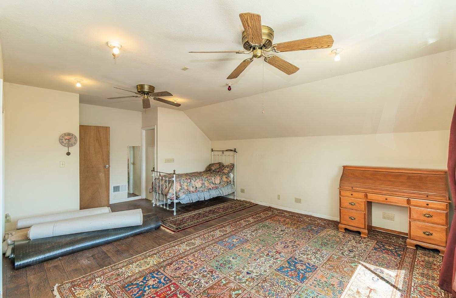 13016 Violet Lane Clovis, CA 93619 - Photo 28 of 41 a bedroom with a bed and a chandelier