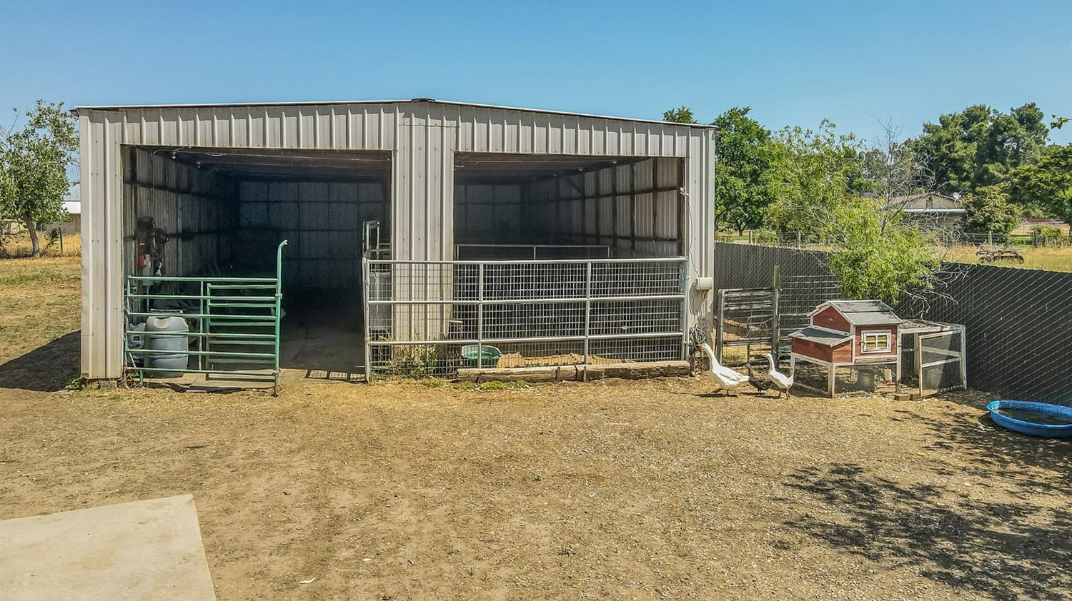 13016 Violet Lane Clovis, CA 93619 - Photo 32 of 41 a view of a house with a door and wooden fence