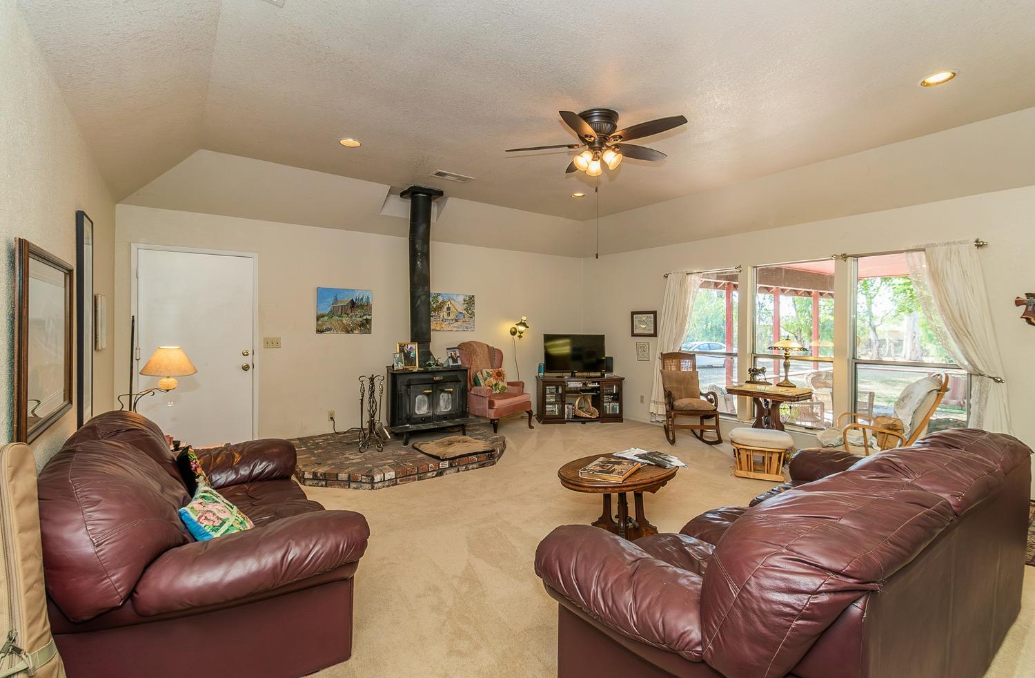 13016 Violet Lane Clovis, CA 93619 - Photo 7 of 41 a living room with furniture ceiling fan and a large window