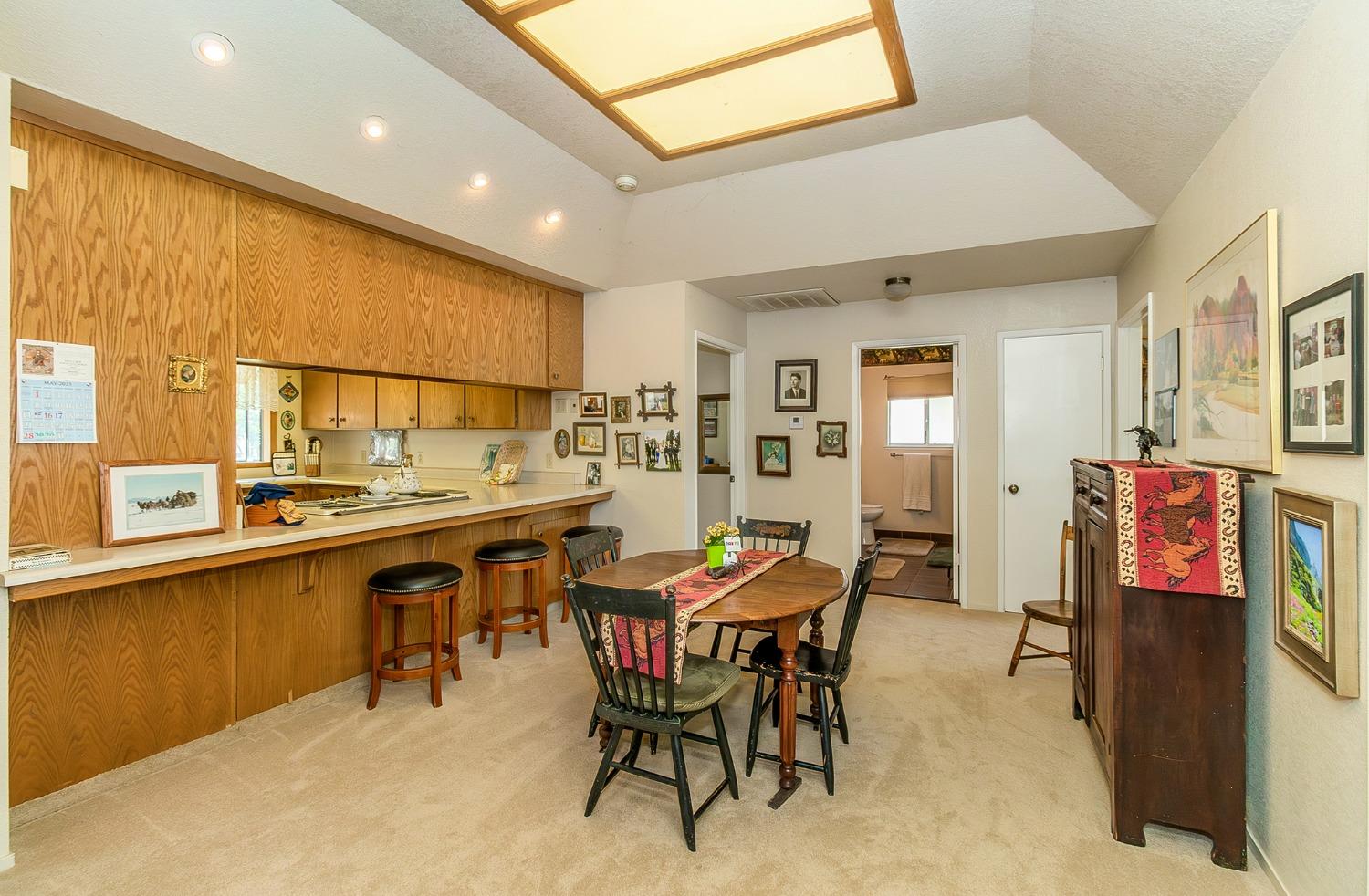 13016 Violet Lane Clovis, CA 93619 - Photo 10 of 41 a dining hall with stainless steel appliances a dining table and chairs