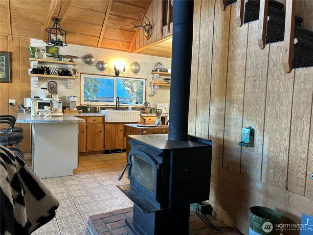 a kitchen with stainless steel appliances granite countertop a sink a stove and a refrigerator