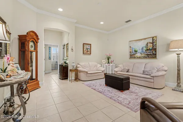 a living room with furniture a chandelier and a chandelier