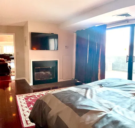 a bedroom with a bed and a fireplace