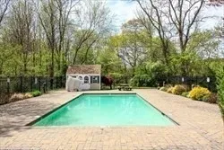 a swimming pool with trees in the background