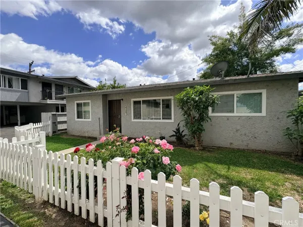 a front view of house with yard and trees