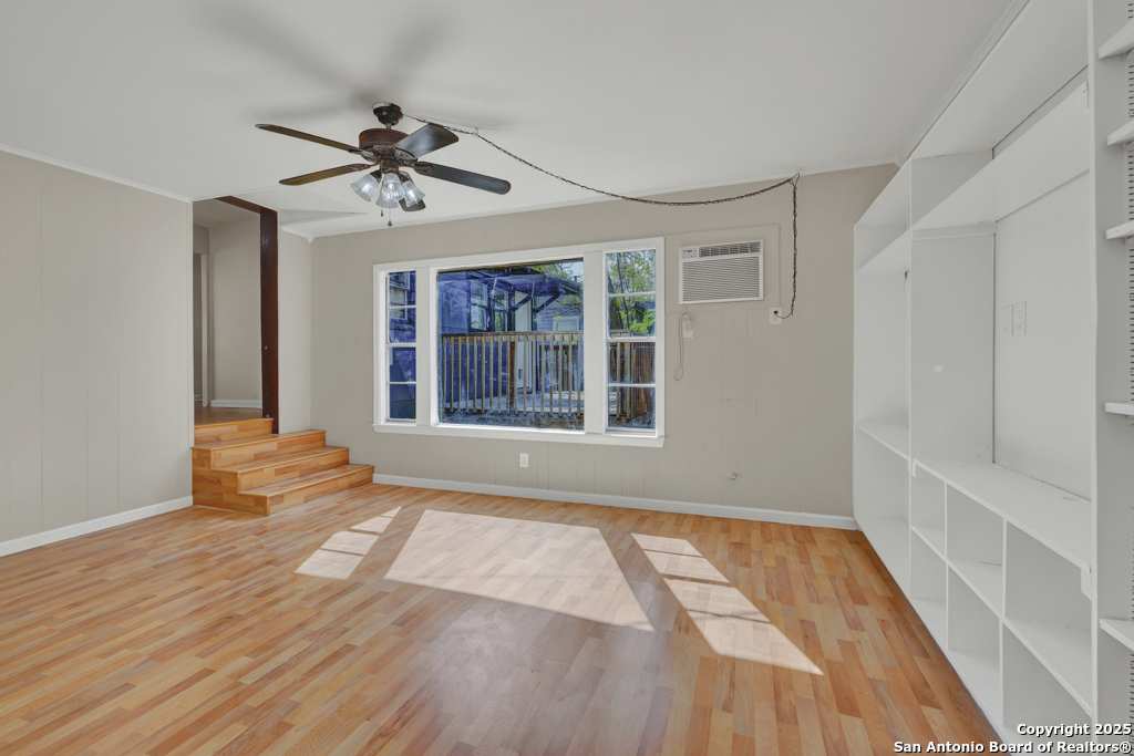 511 Wright Avenue Schertz, TX 78154 - Photo 13 of 23 a view of an empty room with a window and wooden floor