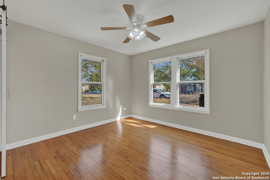 511 Wright Avenue Schertz, TX 78154 - Photo 15 of 23 a view of an empty room with wooden floor and a window
