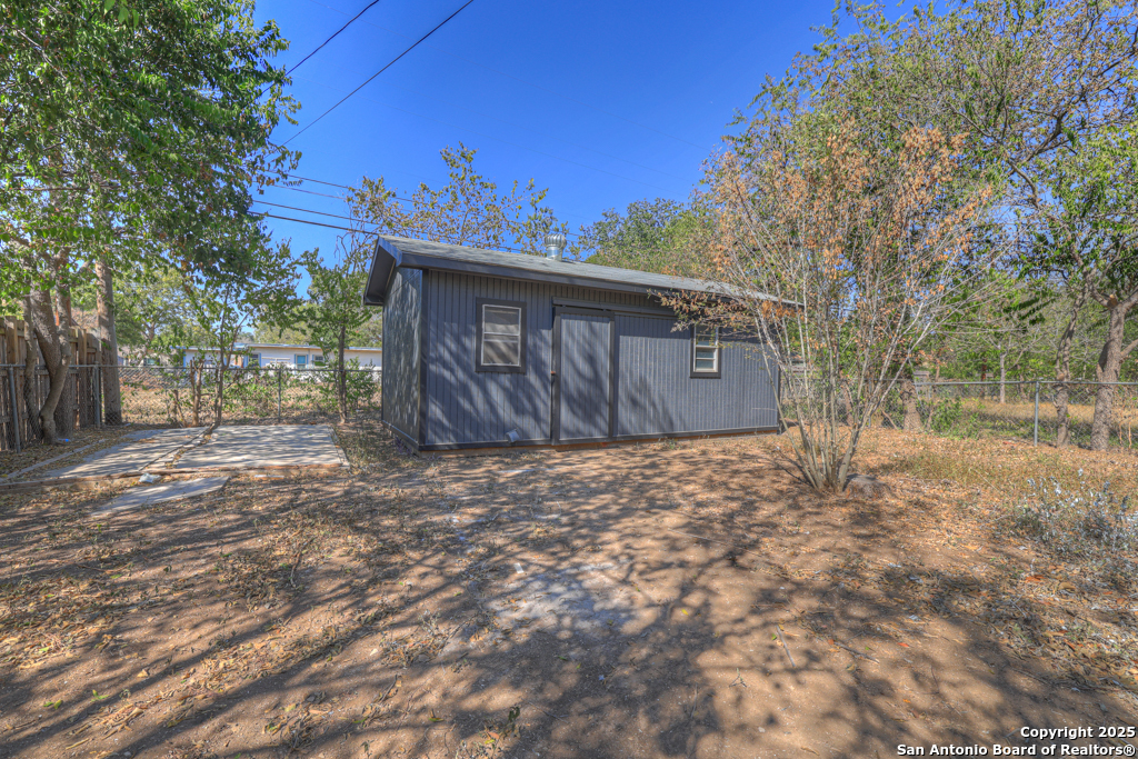 511 Wright Avenue Schertz, TX 78154 - Photo 22 of 23 a view of a backyard with a large tree