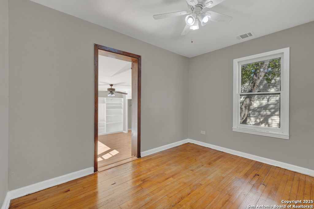511 Wright Avenue Schertz, TX 78154 - Photo 9 of 23 a view of an empty room with wooden floor and a window