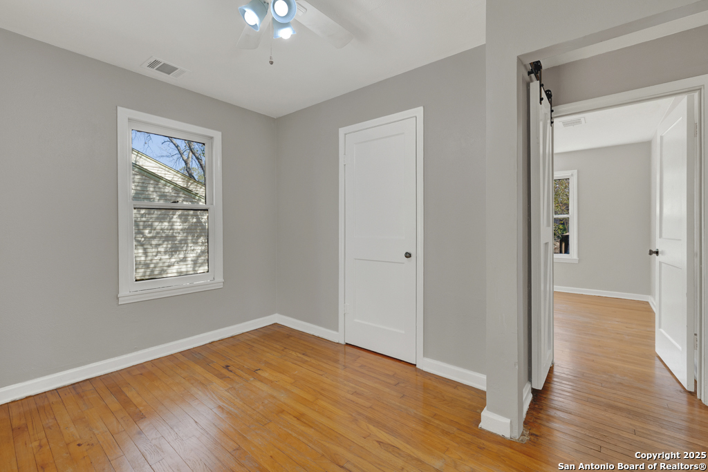 511 Wright Avenue Schertz, TX 78154 - Photo 10 of 23 a view of an empty room with wooden floor and a window
