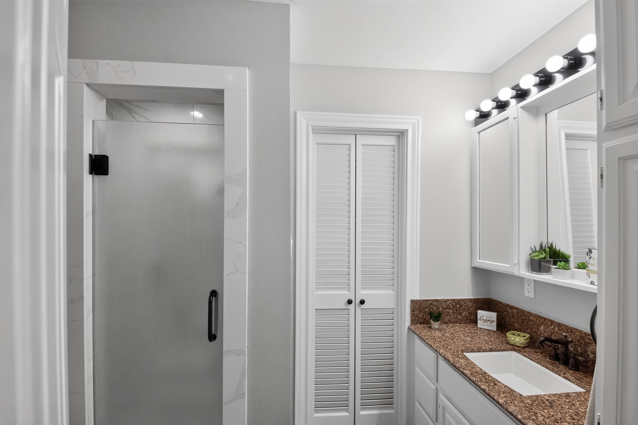 1950 Country Club Road Brenham, TX 77833 - Photo 26 of 39 Granite counters and a clean shower stall create a fresh and functional bathroom.