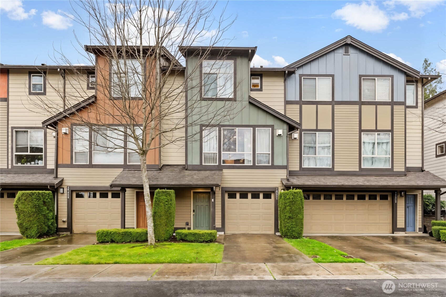 a front view of a building with a garden and plants