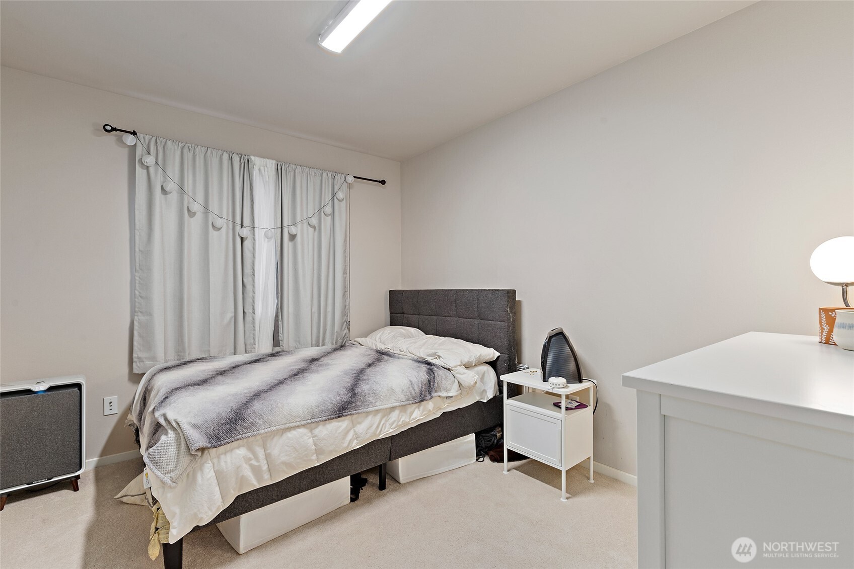 16522 1st Park Southeast Bothell, WA 98012 - Photo 17 of 29 a bedroom with a bed and a table in it