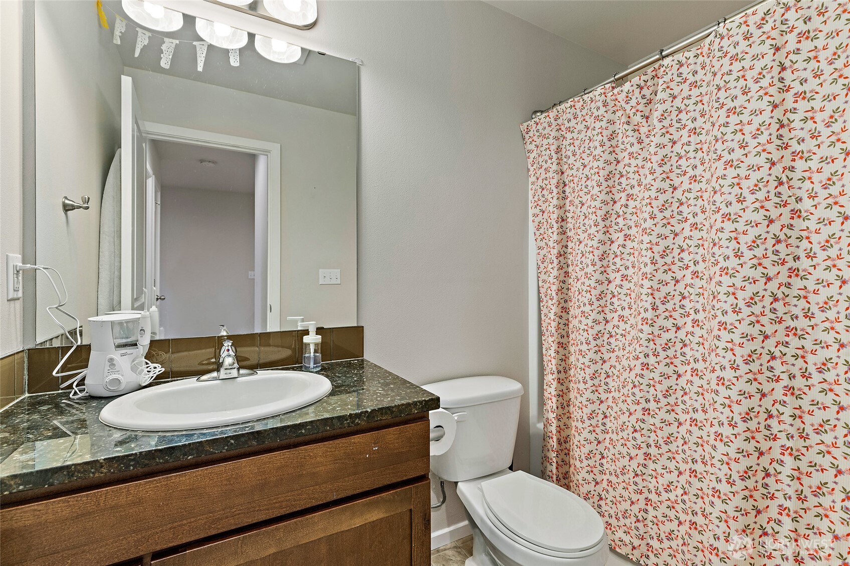 16522 1st Park Southeast Bothell, WA 98012 - Photo 18 of 29 a bathroom with a granite countertop sink toilet mirror and shower