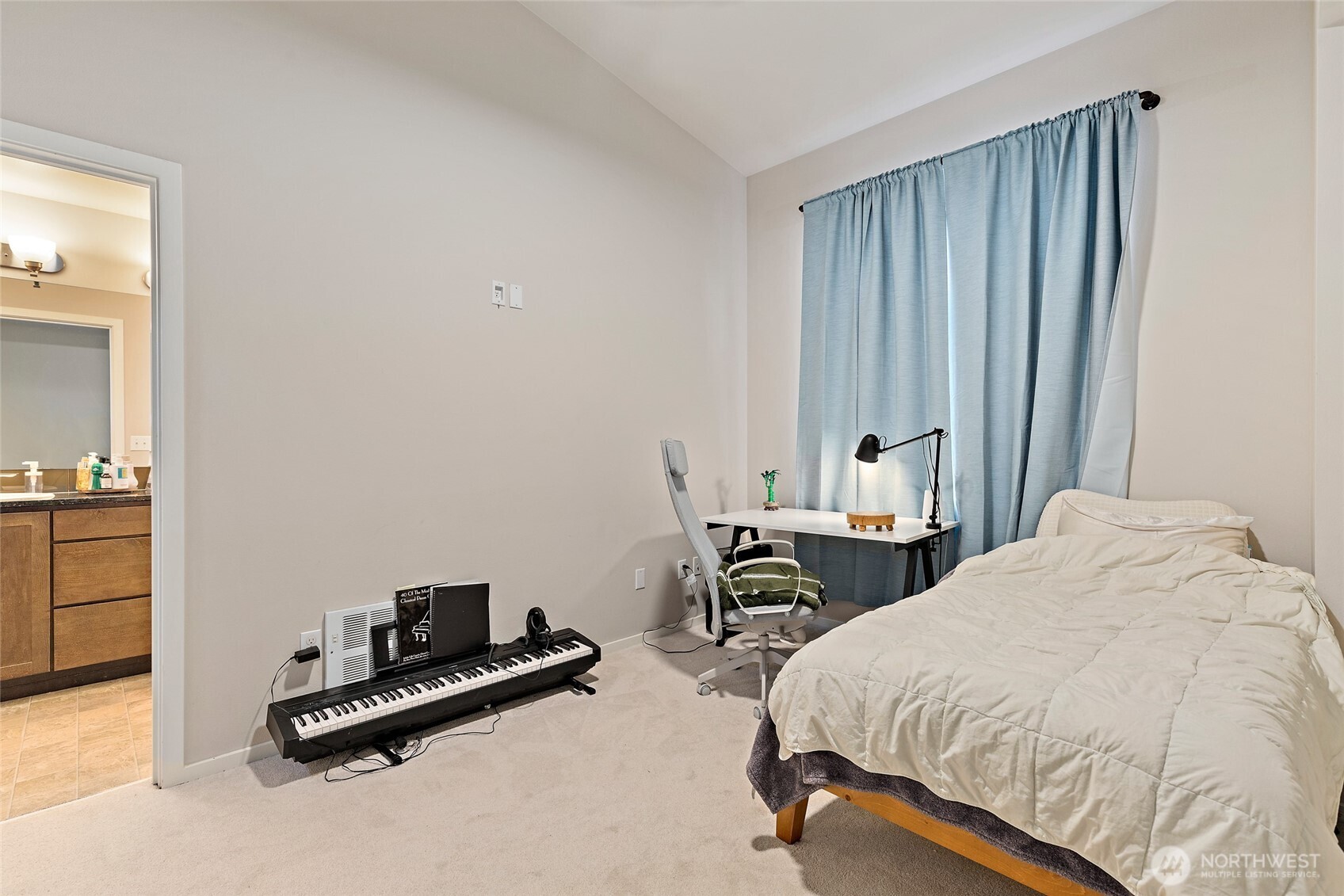 16522 1st Park Southeast Bothell, WA 98012 - Photo 19 of 29 a bedroom with a bed a table and chair