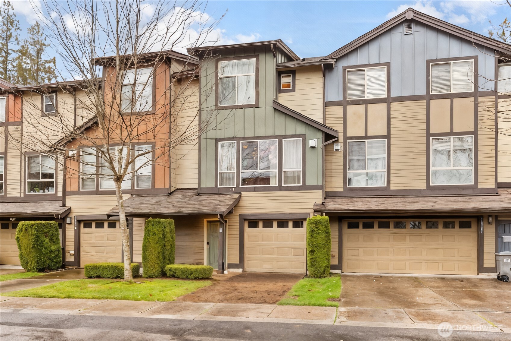 16522 1st Park Southeast Bothell, WA 98012 - Photo 2 of 29 a front view of a residential apartment building with a yard and garage
