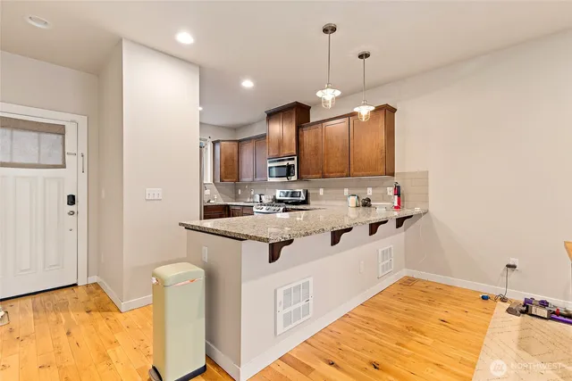 a kitchen with kitchen island granite countertop a sink cabinets and window
