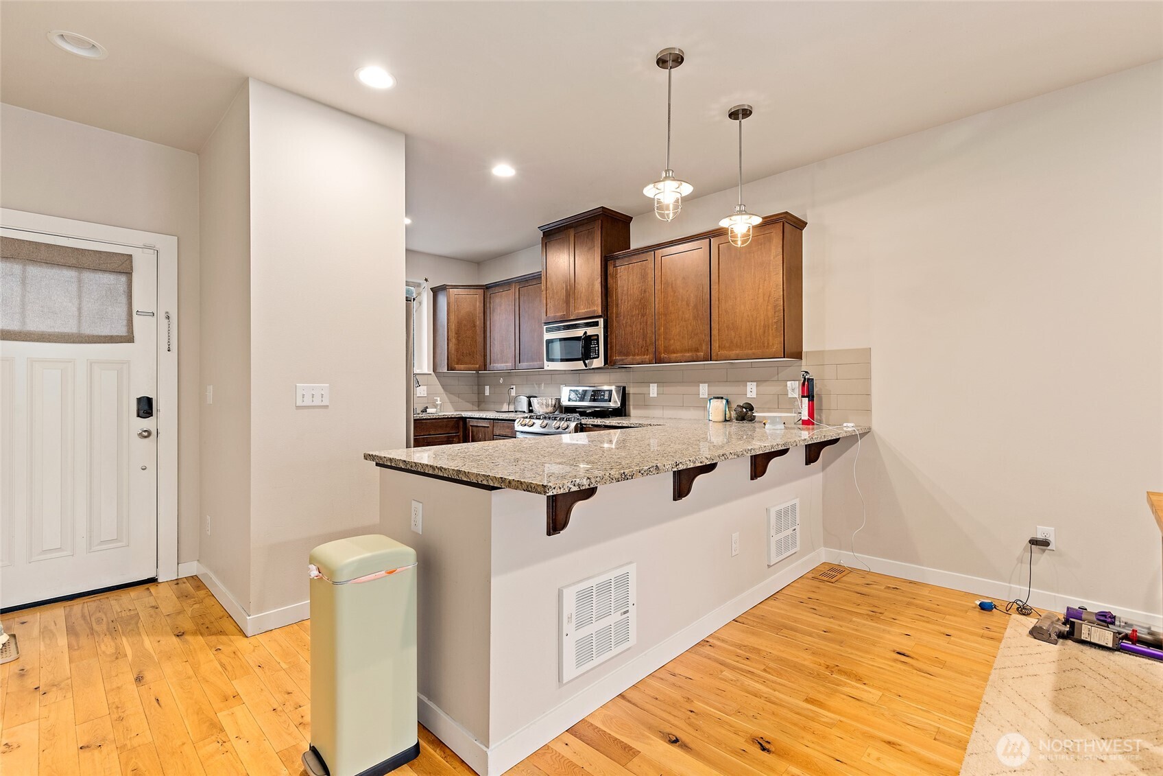 16522 1st Park Southeast Bothell, WA 98012 - Photo 5 of 29 a kitchen with kitchen island granite countertop a sink cabinets and window