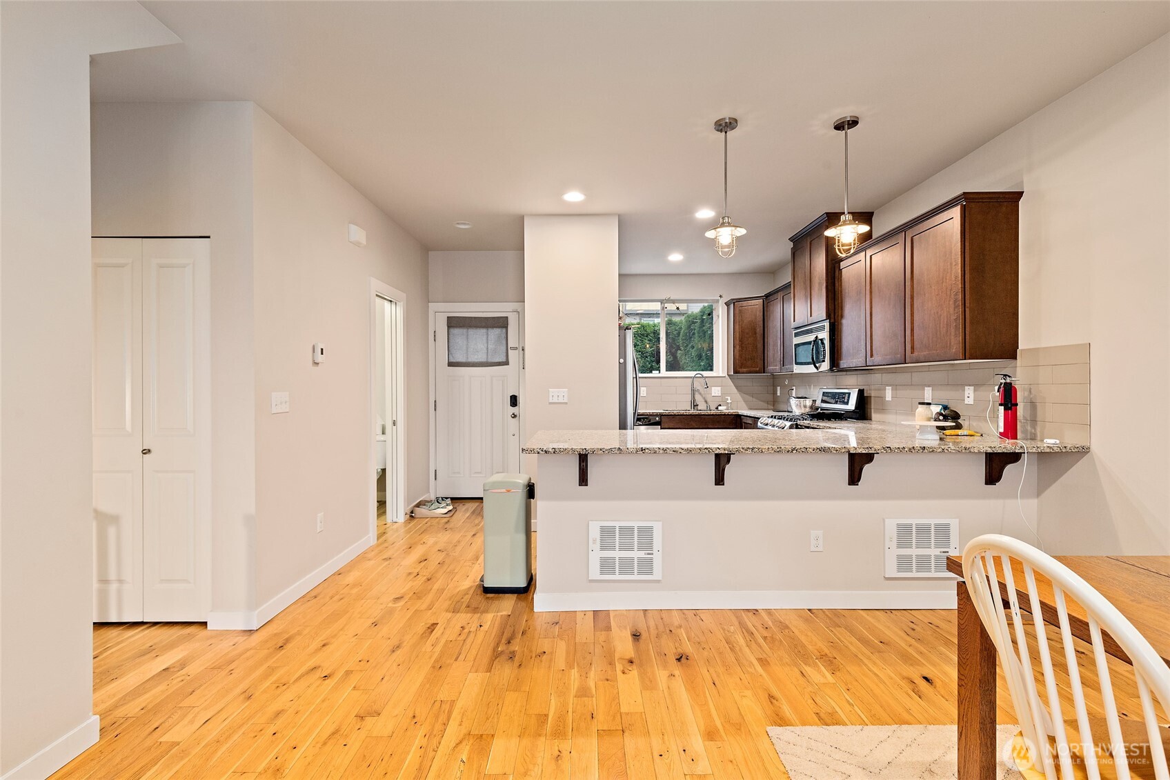 16522 1st Park Southeast Bothell, WA 98012 - Photo 6 of 29 a large white kitchen with kitchen island a sink stainless steel appliances and cabinets