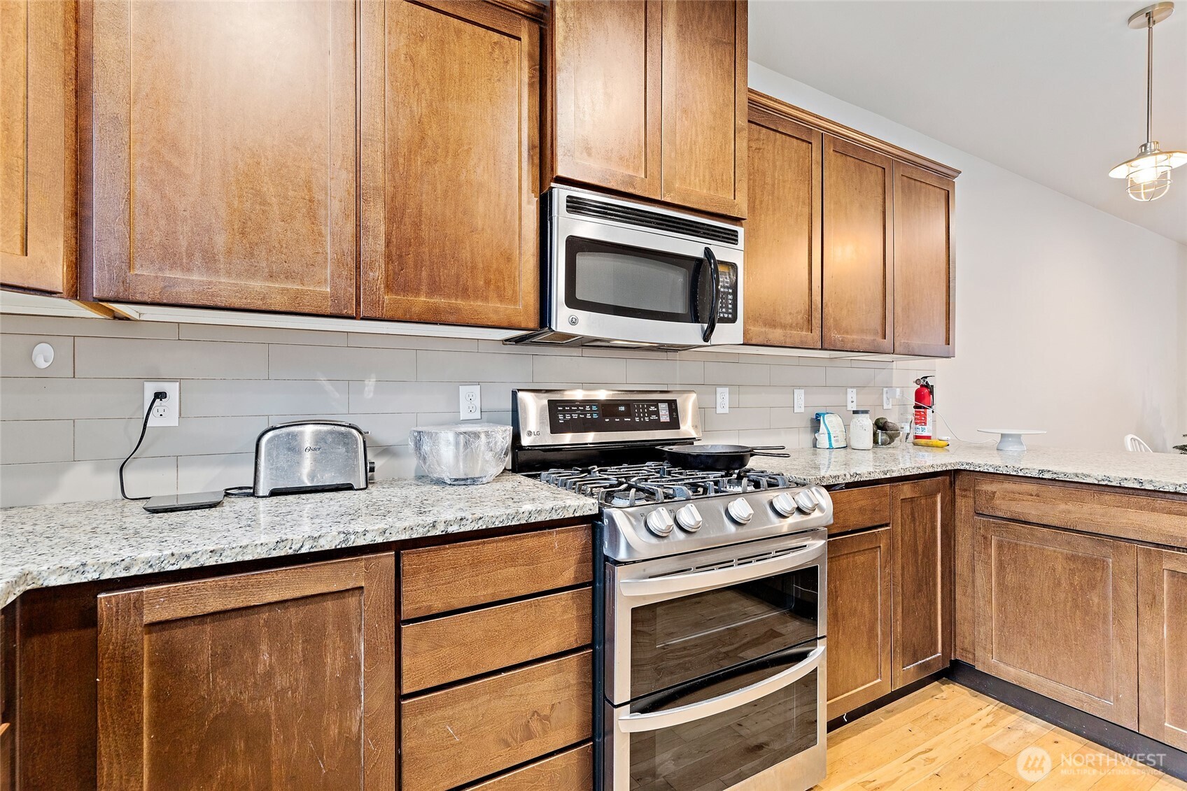 16522 1st Park Southeast Bothell, WA 98012 - Photo 10 of 29 a kitchen with granite countertop stainless steel appliances a stove sink and cabinets