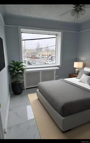 a bedroom with a bed and a large window