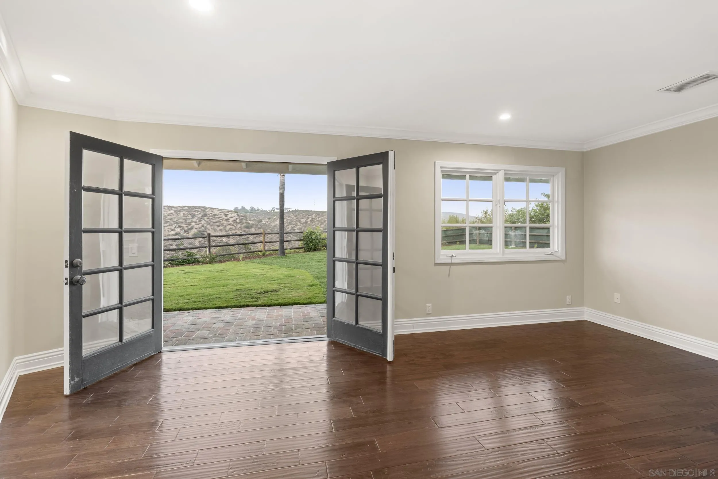 16551 Zumaque Street Rancho Santa Fe, CA 92067 - Photo 28 of 58 Bedroom #3 with wood flooring, french doors to back yard with big peaceful views
