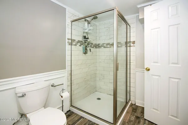 a bathroom with a shower a toilet and a sink