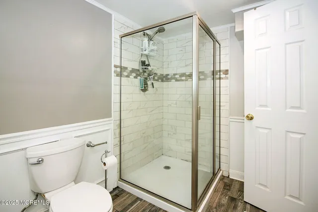 a bathroom with a shower a toilet and a sink