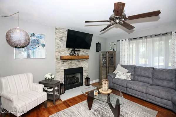 a living room with furniture a flat screen tv and a fireplace