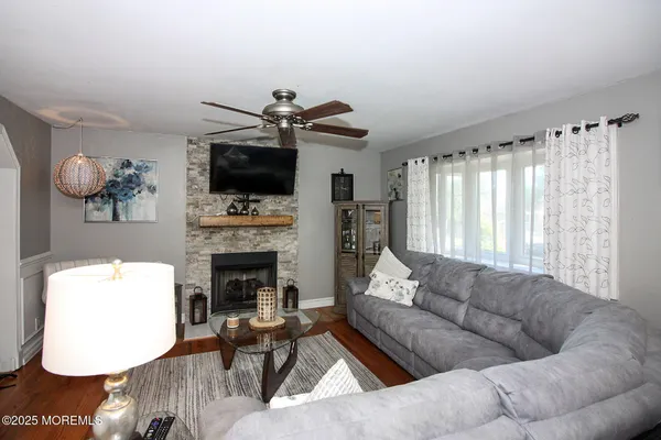 a living room with furniture a flat screen tv and a fireplace