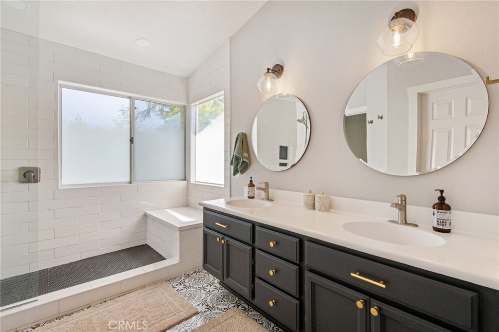40456 Windsor Road Temecula, CA 92591 - Photo 19 of 38 a bathroom with a double vanity sink and a mirror