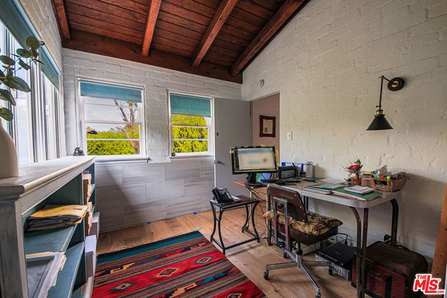 a reading room with furniture and wooden floor