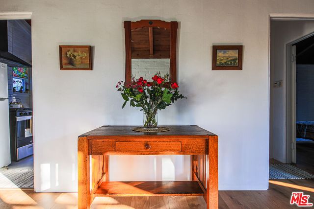 a vase of flowers sitting on a floor