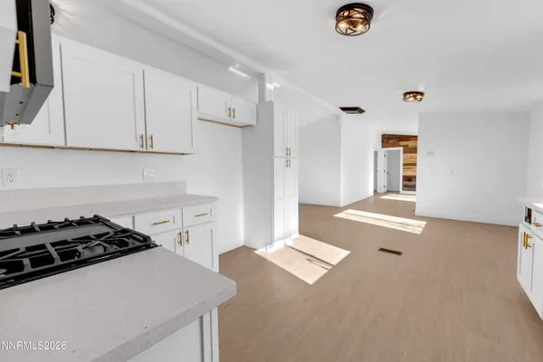 a kitchen with a stove a sink and a refrigerator