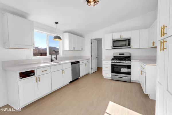 a kitchen with stainless steel appliances a stove sink and cabinets